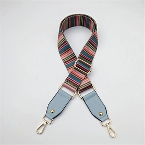 Adjustable rainbow striped woven bag strap with light blue leather ends and gold hooks