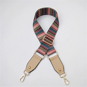 Detail of adjustable colorful striped bag strap with gold hooks and leather ends