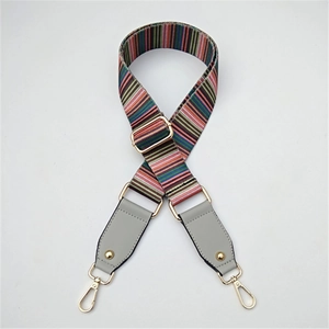 Detail of colorful ethnic style bag strap with adjustable gold buckle and lobster clasps