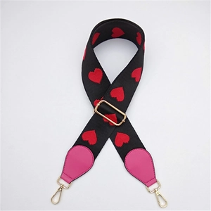 Adjustable wide black bag strap with red heart embroidery and gold metal clasps