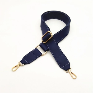 Adjustable dark blue PU leather bag strap with white stitching and gold metal hardware