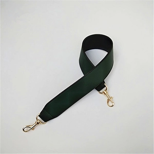 Detail of dark green PU leather shoulder strap with gold metal lobster clasps for handbags