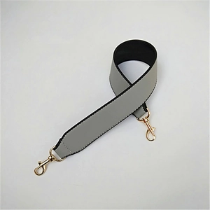 Close-up of wide PU leather replacement bag strap with golden lobster clasps