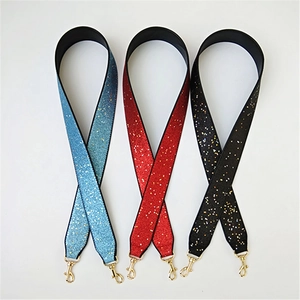 Close-up of glittery replacement shoulder straps in blue, red, and black with gold clasps