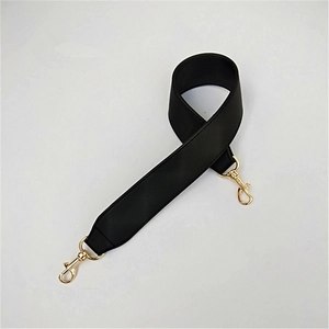Macro shot of wide black PU leather replacement strap with gold metal swivel hooks