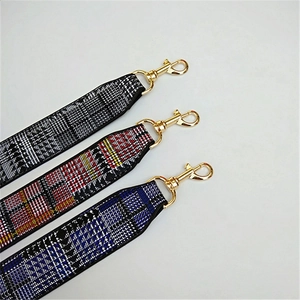 Detail of colorful woven canvas replacement bag straps with premium gold metal clasps