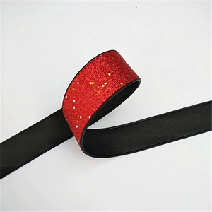 Close-up of wide black PU strap with red glitter stars and golden sequins detail