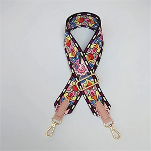 Close-up of colorful Bohemian patterned wide shoulder strap with gold lobster clasps