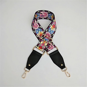Close-up of colorful Bohemian patterned wide strap with gold alloy hooks and leather ends