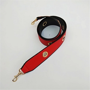 Detail of red PU leather replacement strap with gold metal eyelets and rotating hooks