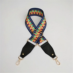 Detail of colorful geometric woven strap with premium gold lobster clasps and black leather ends