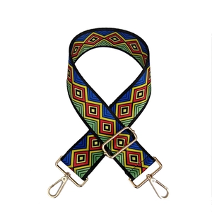 Close-up of adjustable colorful geometric diamond pattern bag strap with gold hooks