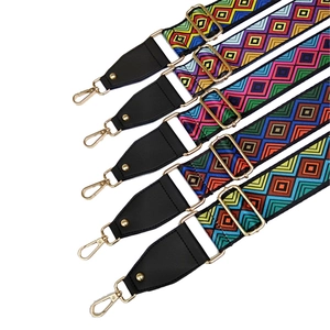 Detail of five adjustable ethnic style handbag straps with colorful geometric patterns