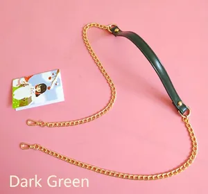 Detail view of dark green PU leather strap with golden metal chain and lobster clasps