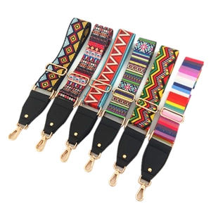 Detailed view of adjustable ethnic style woven straps with gold metal hardware and clips