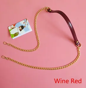 Detail view of wine red PU leather strap and gold metal chain with lobster clasp for bags