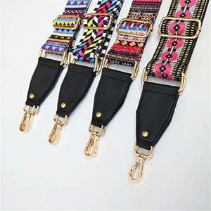 Close-up of bohemian style woven bag straps with golden metal hooks and leather ends