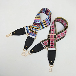 Close-up of bohemian wide shoulder straps with gold metal hooks and leather ends