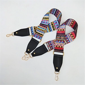 Close-up of bohemian woven straps with geometric patterns and golden metal swivel hooks