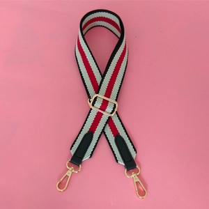 Adjustable wide woven shoulder strap with red black white stripes and gold metal hooks