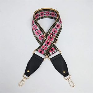 Detail of adjustable geometric strap with pink diamond patterns and golden metal hardware