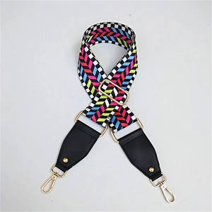 Adjustable wide replacement bag strap with colorful woven geometric patterns and gold clips
