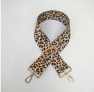 Close-up of leopard print wide replacement strap with gold metal buckles and adjuster