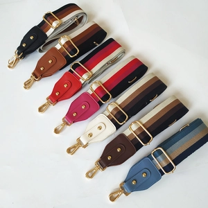 Detail of colorful striped canvas bag straps with gold metal hooks and thick weaving