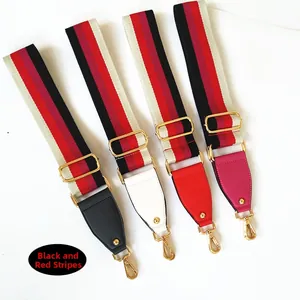 Detail view of adjustable striped canvas bag straps with colorful leather ends and gold buckles