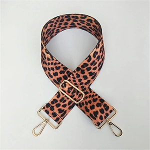Detail of adjustable leopard print bag strap with golden metal lobster clasps