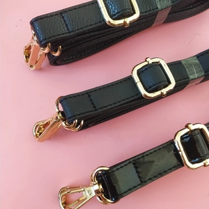 Adjustable black PU leather straps in litchi, cross-grain, and patent finishes with gold hooks
