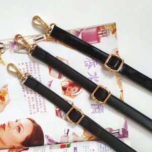 Close-up of black PU leather straps with litchi, saffiano, and patent texture and gold buckles