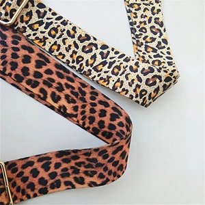 Detail view of two leopard print bag straps with high-quality gold metal adjusters