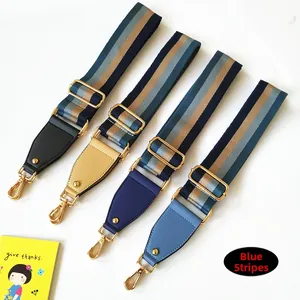Adjustable wide nylon bag straps in blue stripes with leather ends and gold hardware