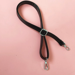 Close-up of black adjustable PU leather strap with silver metal buckle and lobster clasps