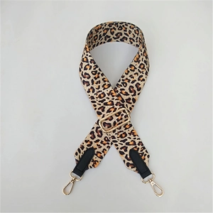 Detail of leopard print wide strap with gold adjustable buckle and rotating metal hooks
