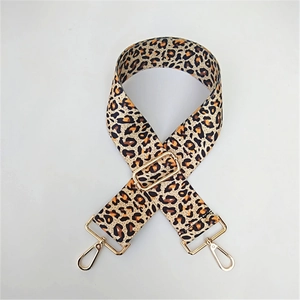 Detailed close-up of leopard print replacement shoulder strap with gold metal buckles
