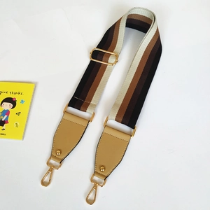 Adjustable wide striped bag strap with brown leather and gold metal buckle detail