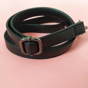 Close-up of black litchi pattern PU leather strap with dark gunmetal adjustable buckle