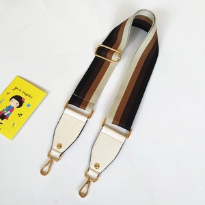Detail of adjustable wide striped strap with brown tones and gold metal snap hooks