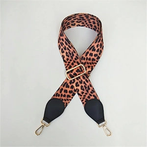 Detail of adjustable leopard print bag strap with gold metal hardware and lobster clasps