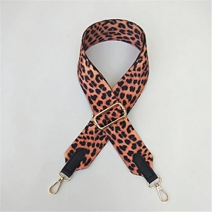 Detail of leopard print wide strap with gold hardware and adjustable buckle for crossbody bags
