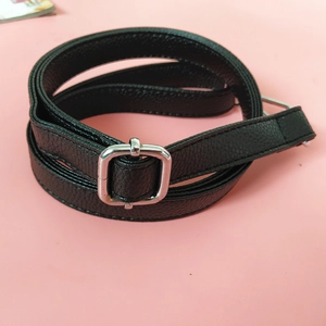 Detail of adjustable black litchi pattern PU leather strap with silver metal buckle