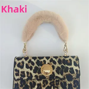Close-up of leopard print handbag with plush khaki fur handle and gold twist lock
