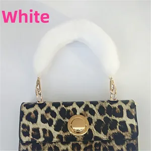 Detail of leopard print handbag with white plush faux fur handle and golden ring connector