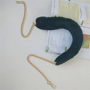 Detail of black faux fur shoulder strap with gold metal chain and swivel lobster clasps