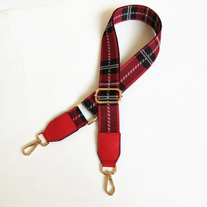 Adjustable red and black checkered wide shoulder strap with gold metal hooks on white background