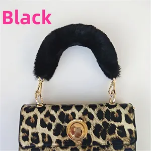 Detail of leopard print handbag featuring a black plush faux fur handle and gold metal lock