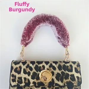 Close-up of wine red faux fur handle and leopard print crossbody bag with gold metal lock