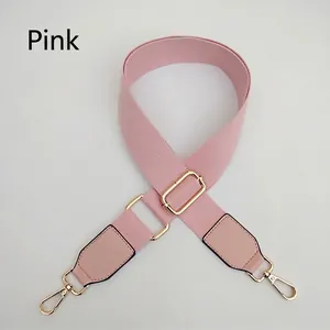 Pink adjustable wide fabric bag strap with golden metal hardware and faux leather ends